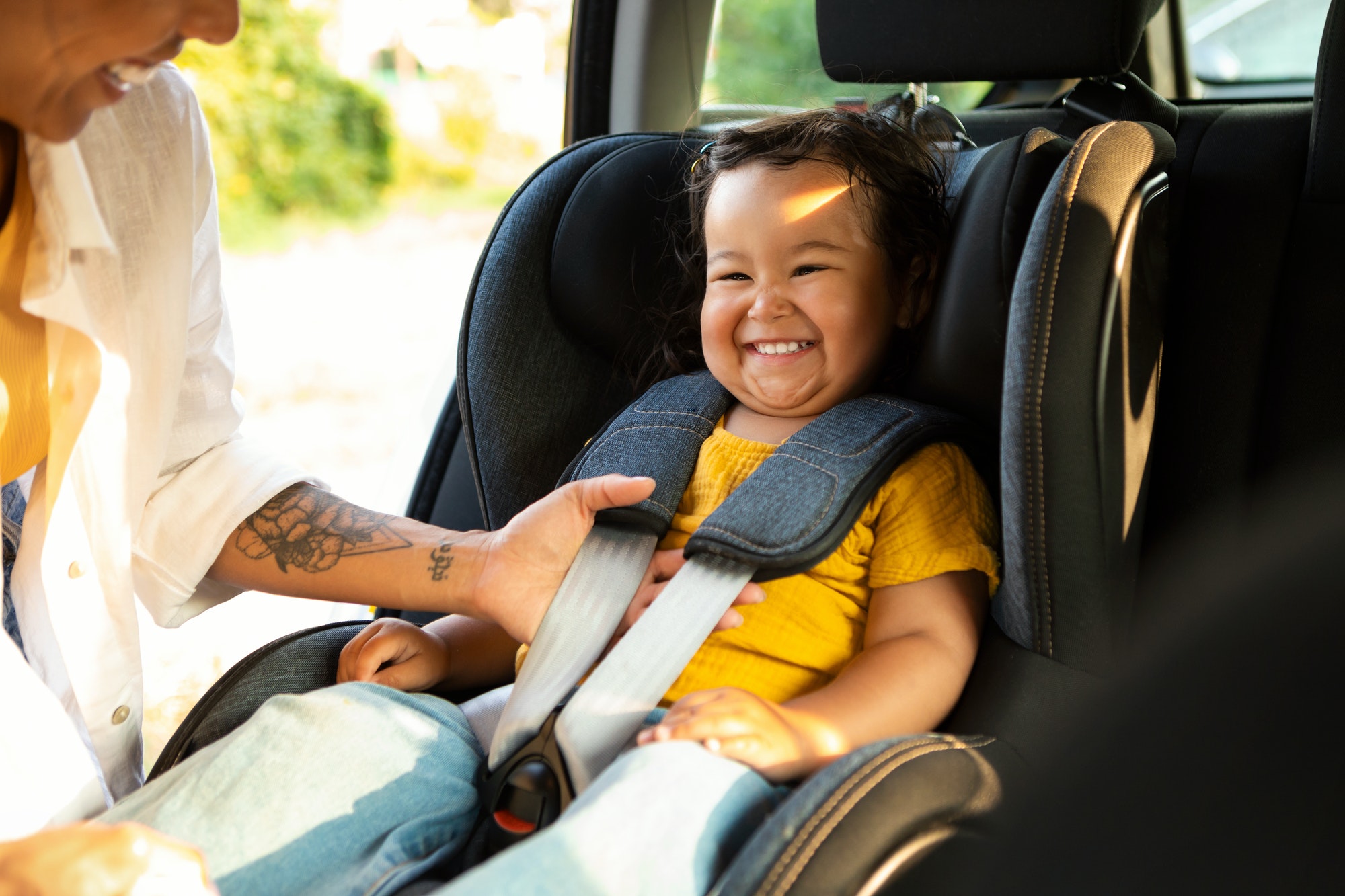 Mother Ensures Infant Safety In Car Seat In Automobile - Children's Medical Group
